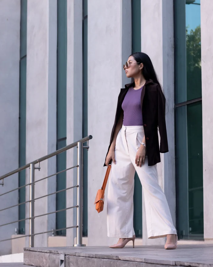 A woman wearing wide-leg trousers with sweater fall work outfit