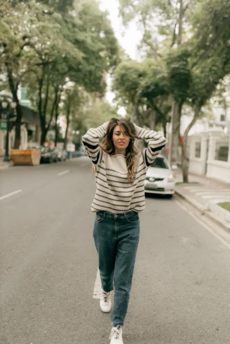 A woman wearing chinos and striped sweater fall outfit